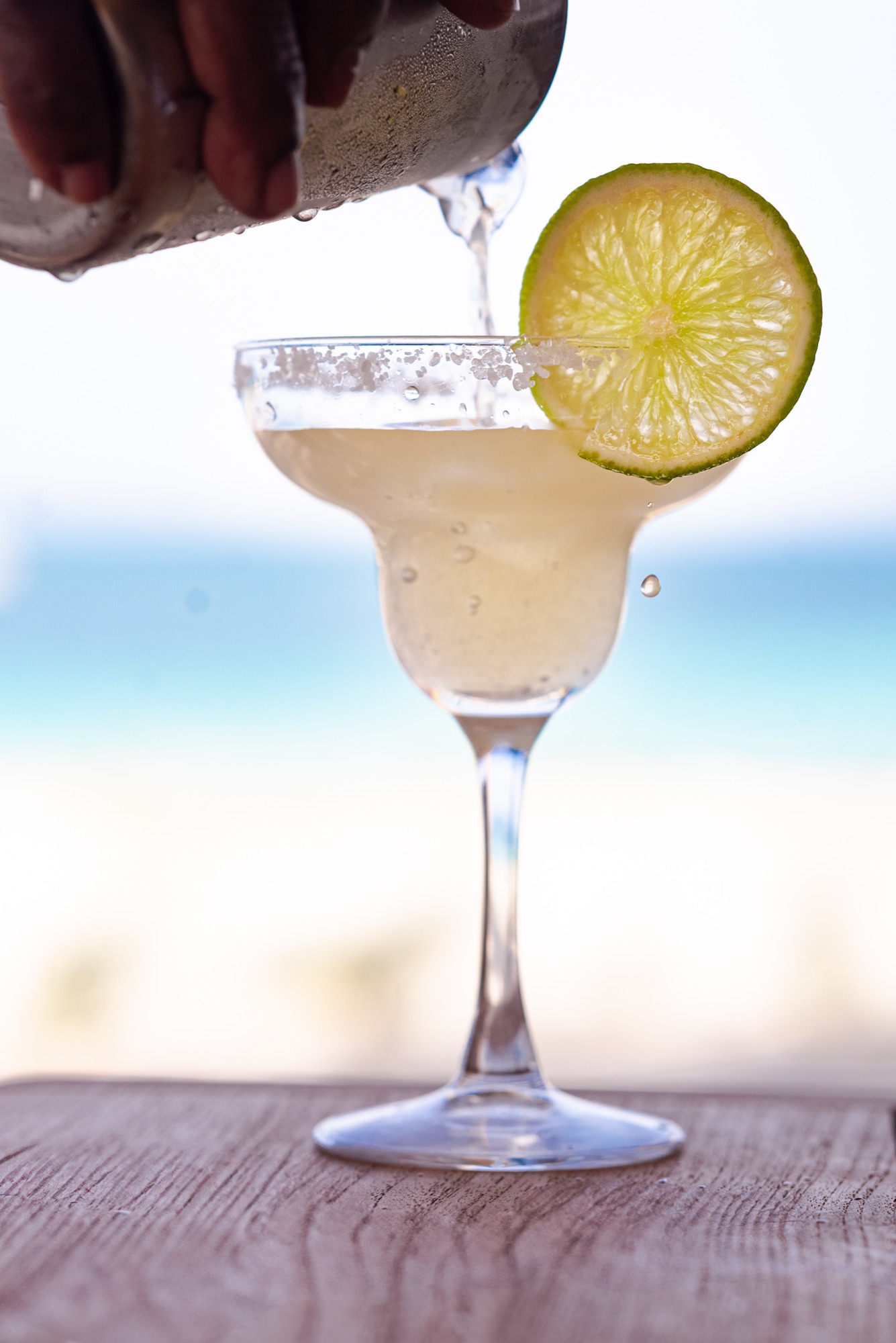 Pouring a margarita by the water